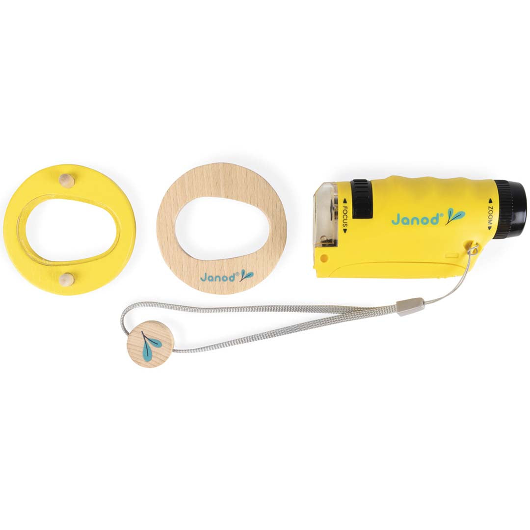 Janod draagbare microscoop, een houten ring met geel onderstel en een houten schijfje, van bovenaf gezien.