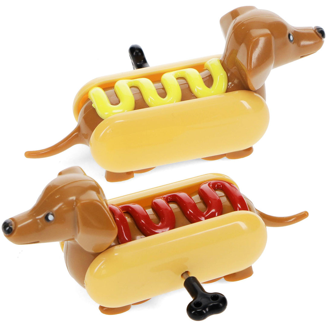 Twee Rex London opwindspeeltjes in de vorm van teckels in hotdogbroodjes, één met gele mosterd en één met rode ketchup.