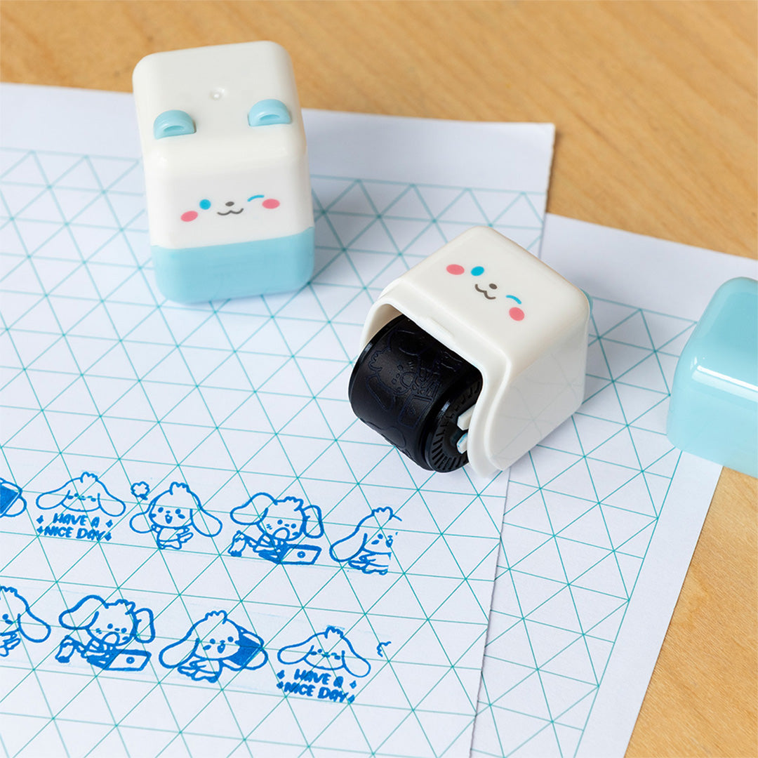 Twee rex london puppy stempelrollers op papier met blauwe afdrukken van puppy's en de tekst 'Have a nice day'.