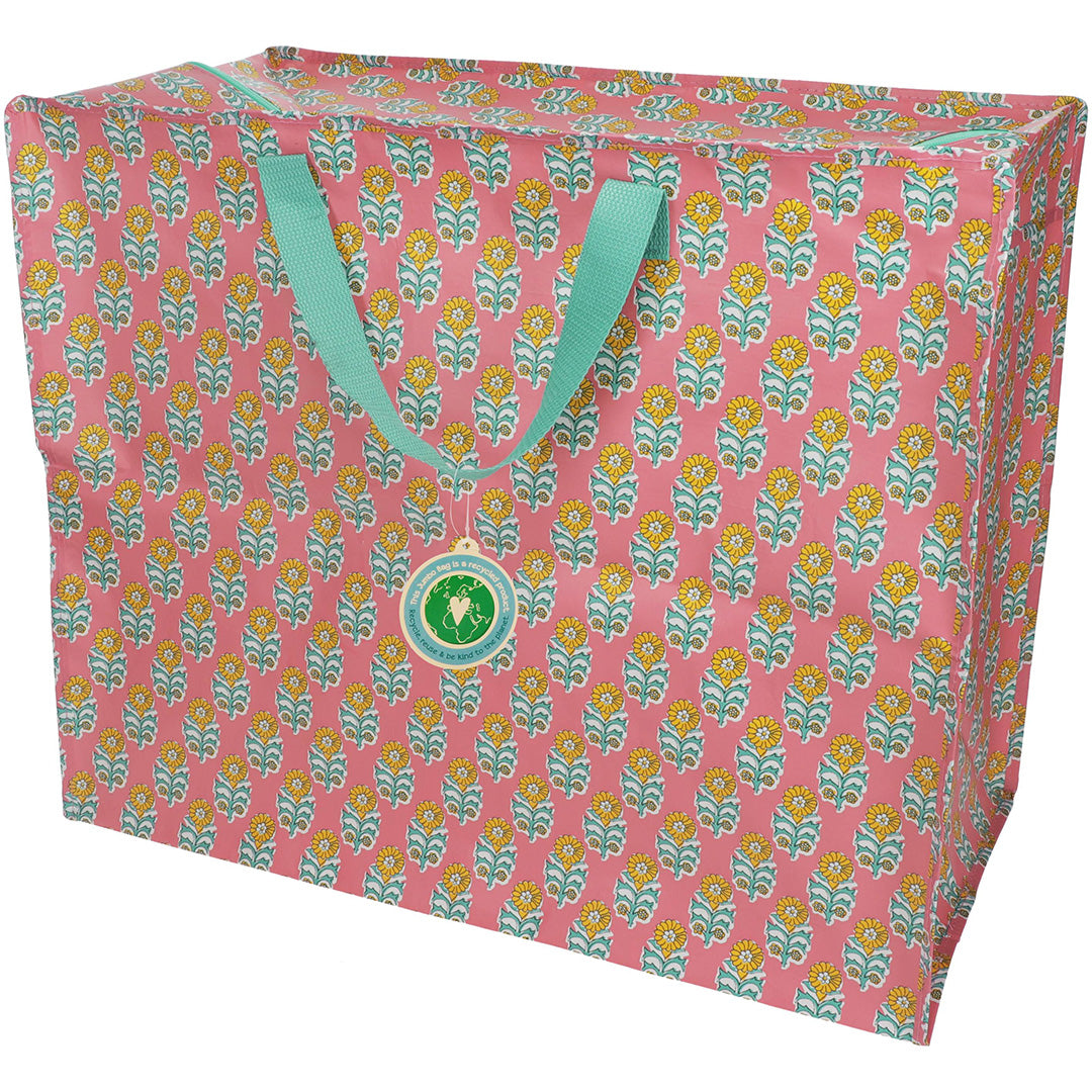 Rex London jumbo opbergtas met roze en geel gebloemd patroon en turquoise hengsels.