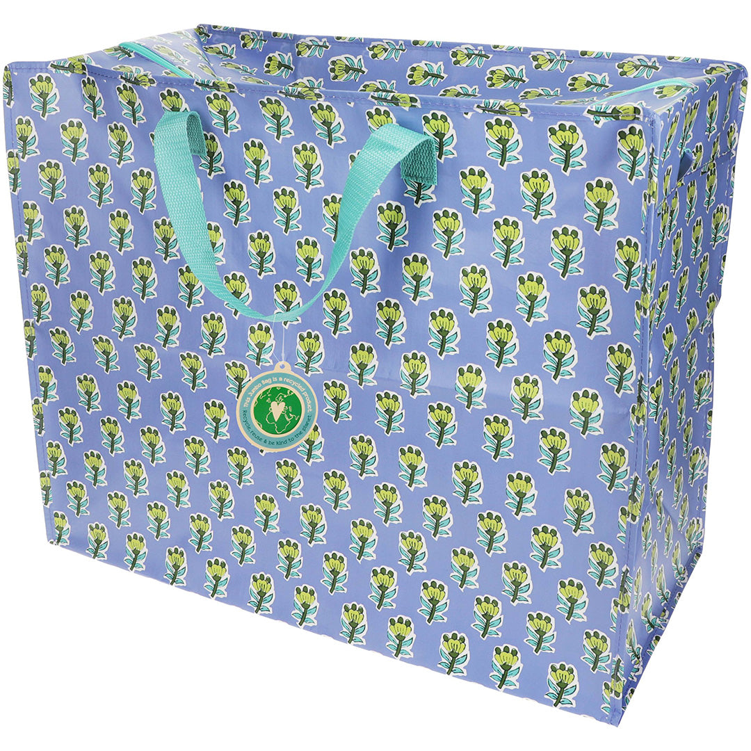 Rex London jumbo opbergtas met blauw-groen bloemenpatroon en groene handvatten.
