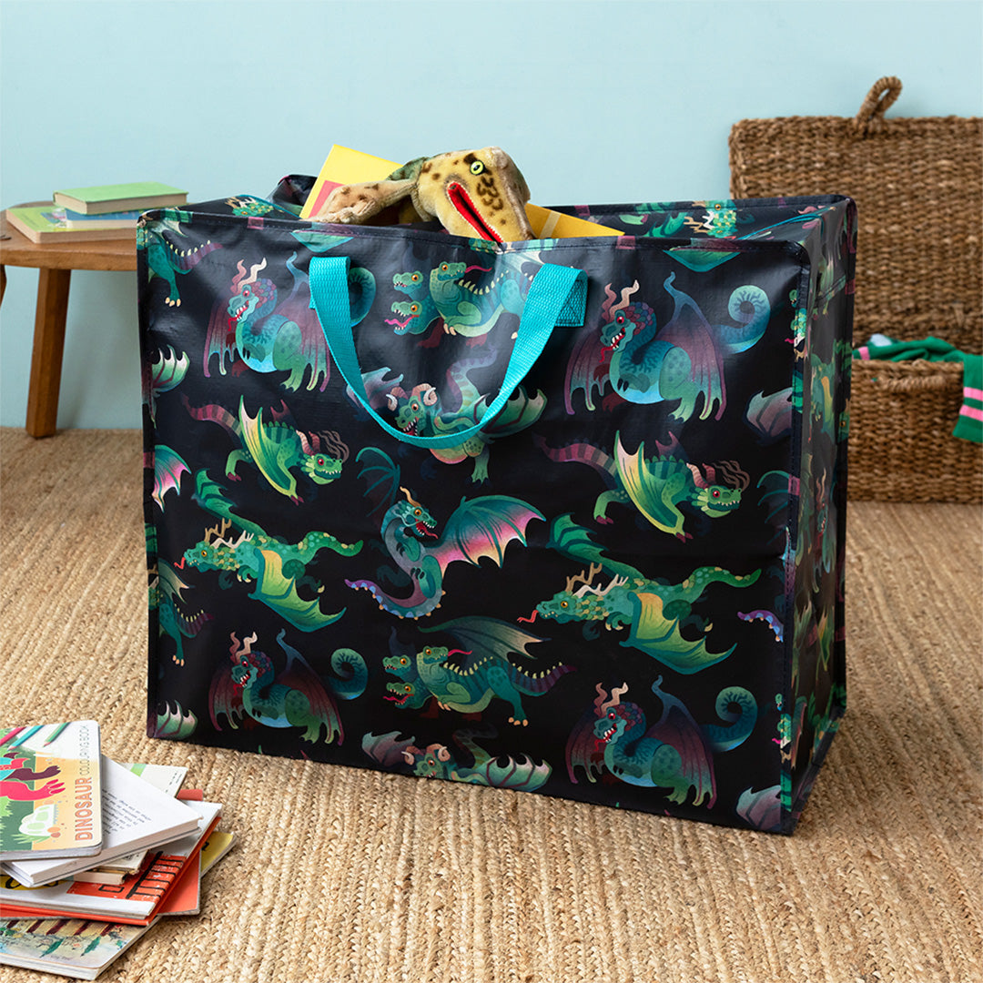 Rex London jumbo opbergtas met drakenpatroon, gevuld met speelgoed en boeken.