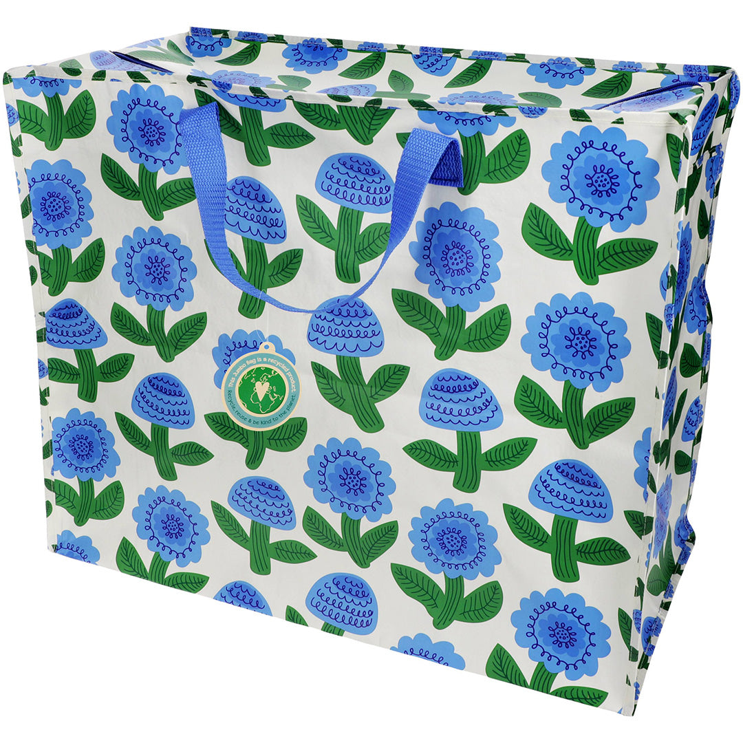 Rex London jumbo opbergtas Florence met blauw bloemenpatroon en een groen label.