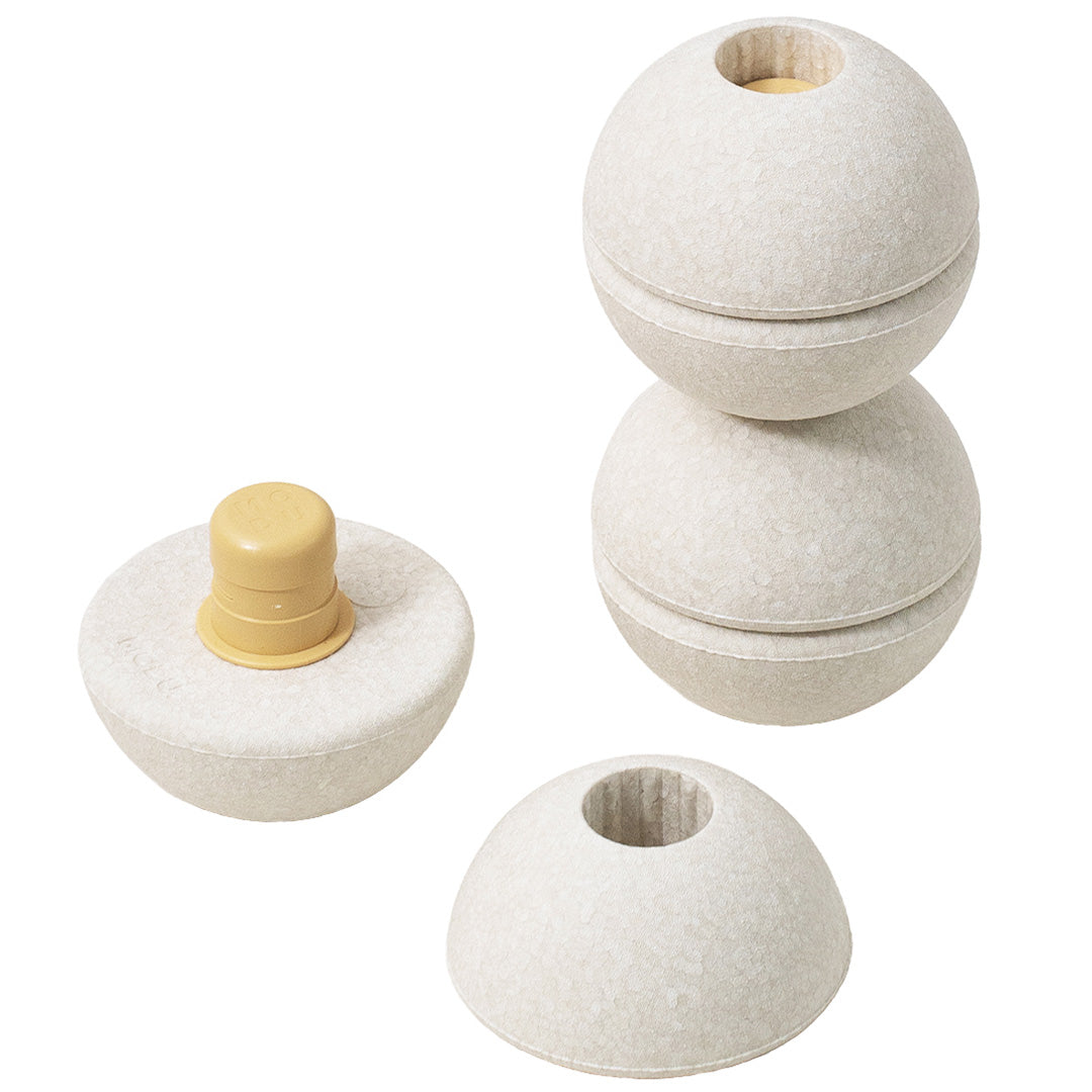 Drie Modu beige schuimrubber bouwballen, waarvan één met gele pin en één in twee helften.