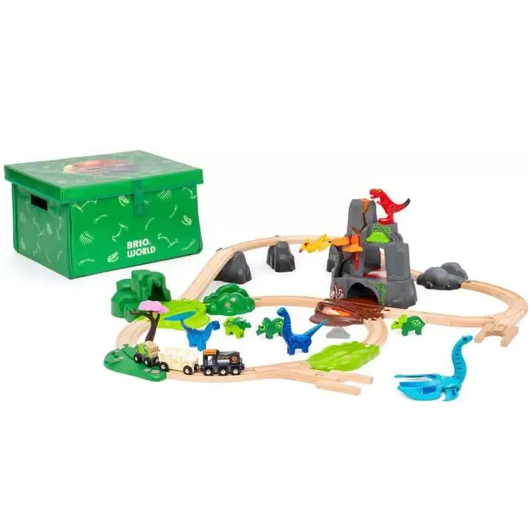 Brio dinosaurus treinbaan speelset met houten rails, tunnel, dinosaurusfiguren en een trein, naast de groene opbergdoos.