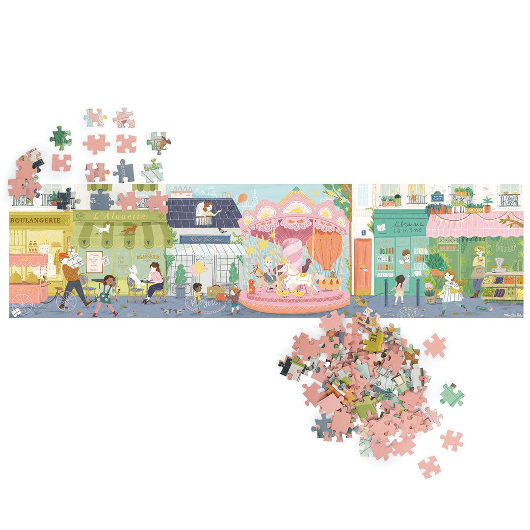 De complete panoramapuzzel met een stadsgezicht, omringd door losse roze en gekleurde puzzelstukjes.