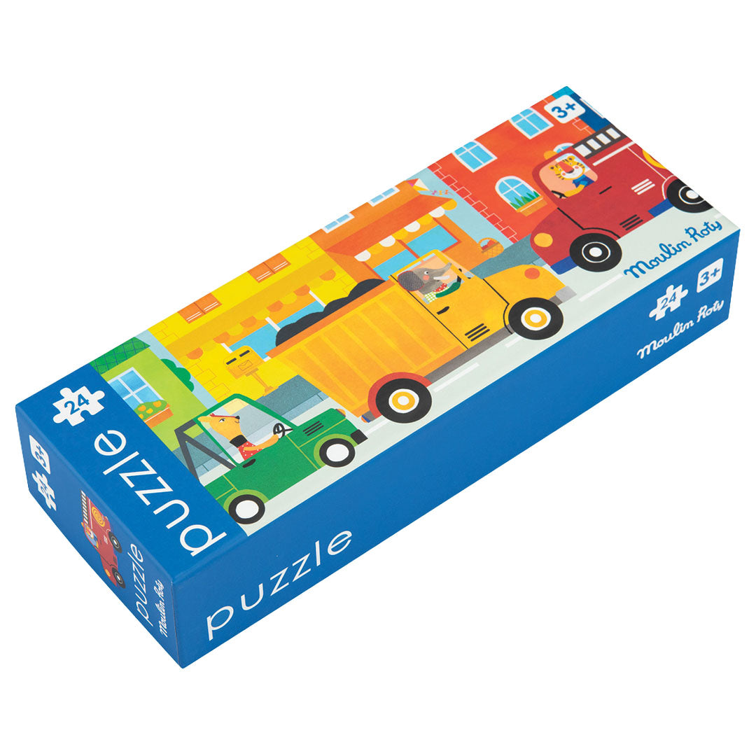 Gesloten Moulin Roty puzzelverpakking met een illustratie van voertuigen in een straat.