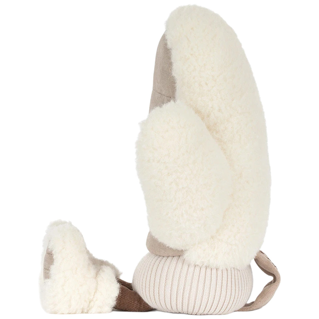 Zijaanzicht van de Jellycat pluchen winterwant knuffel met pluizige witte randen en geribbelde manchet.