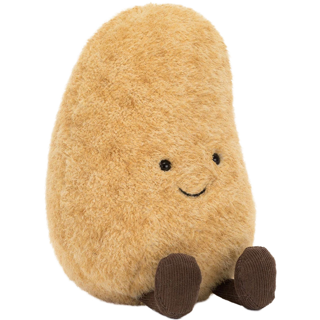 Jellycat knuffelaardappel Graham, beige met bruine voeten, zit schuin naar voren.