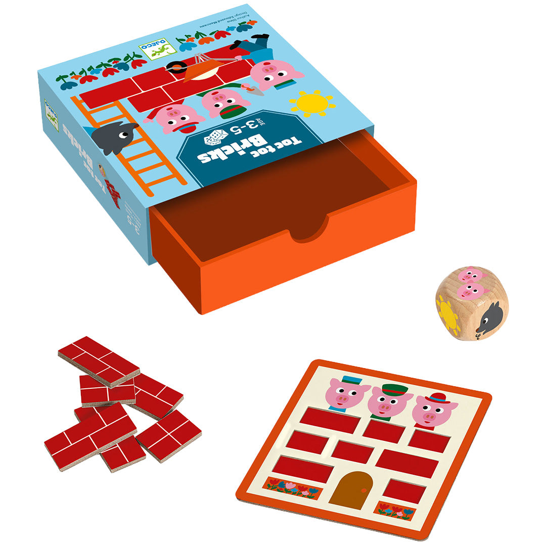 Djeco dobbelspel Toc Toc Bricks met de open doos, een houten dobbelsteen, speelbord en rode baksteen-tokens.