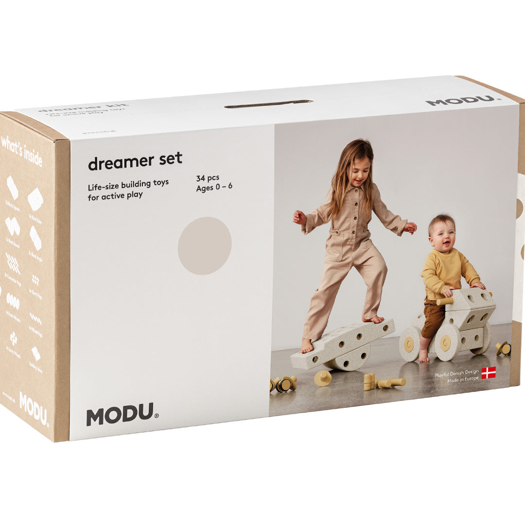 De voorkant van de Modu Dreamer Kit verpakking met afbeeldingen van spelende kinderen.
