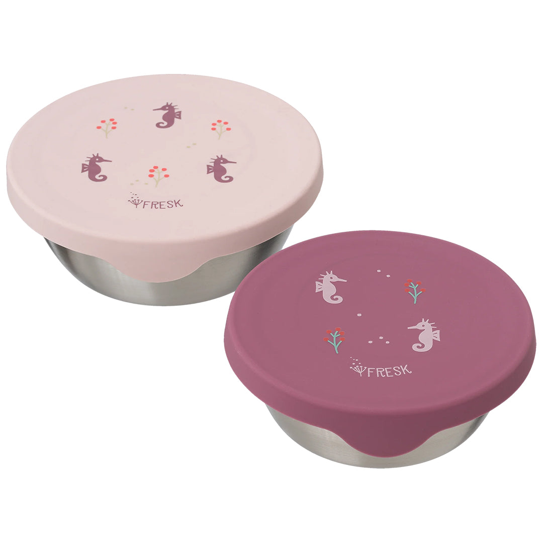 Twee gesloten Fresk rvs snackdoosjes voor kinderen met roze en paarse siliconen deksels met zeepaardjes en bloemen.