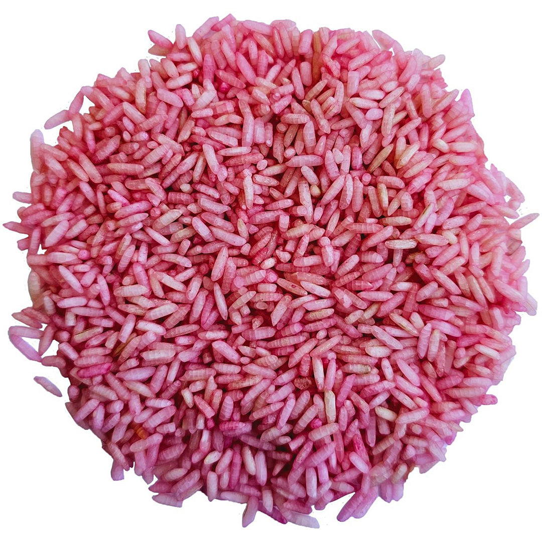 Een hoopje roze grennn speelrijst voor sensorisch speelgoed.