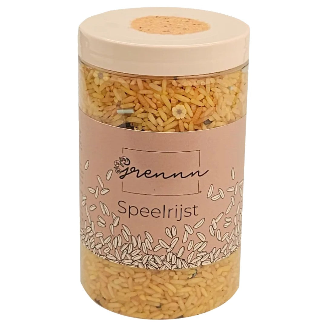 Verpakking van grennn speelrijst bijenmix in een transparante cilinder met een roze etiket.