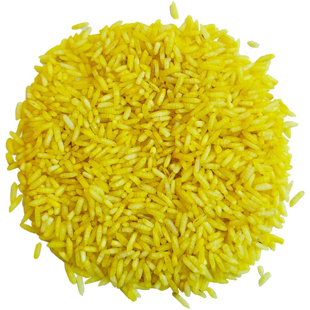 Een hoopje gele grennn speelrijst op een witte achtergrond.