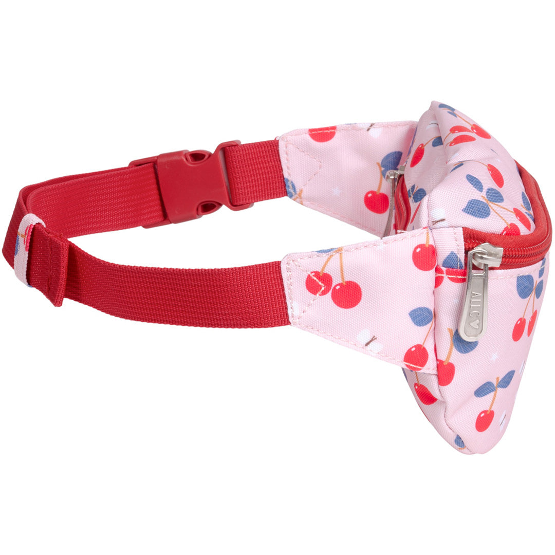Zijaanzicht van de roze a little lovely company kinderheuptas met kersenprint en rode verstelbare band.