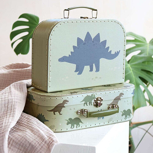 a little lovely company kinderkoffers met dinosaurusprint, gestapeld met plant op de achtergrond.