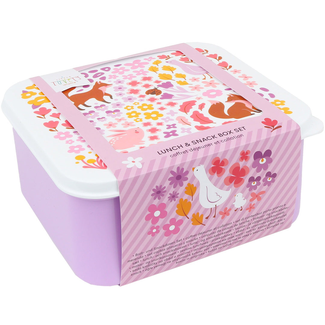 De verpakking van een A Little Lovely Company lunchbox set met bloemen- en dierenpatroon en een roze band met productinformatie.