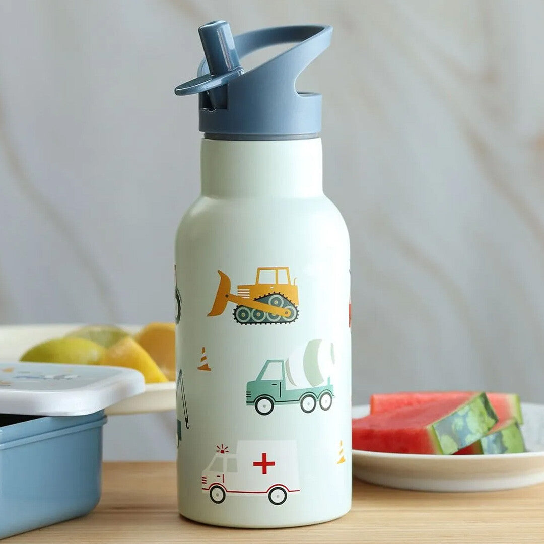 a little lovely company kinderdrinkfles met voertuigenpatroon, staand naast een bord met watermeloen en een lunchbox.