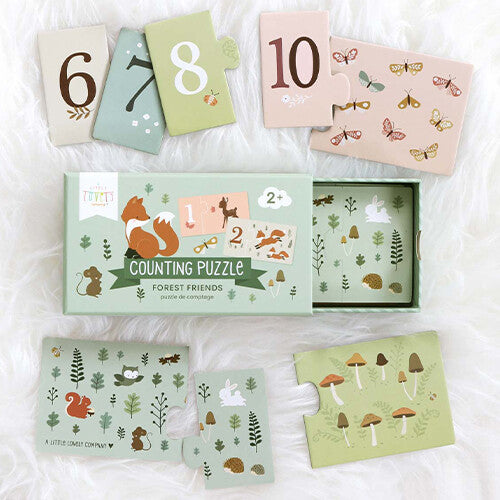 De gesloten doos van de a little lovely company telpuzzel 'Forest Friends' omringd door losse puzzelstukken met nummers en bosdieren.