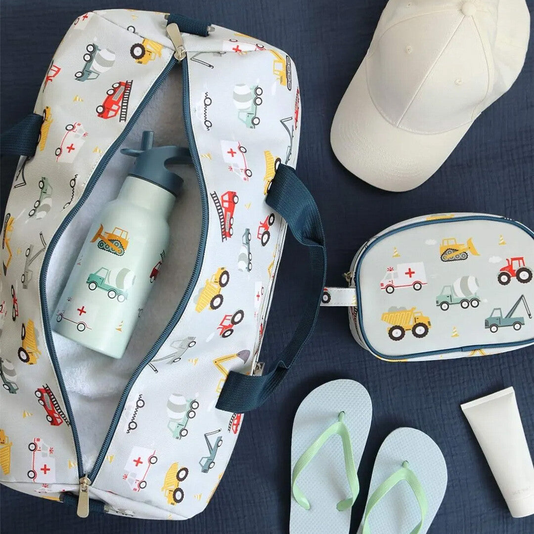 De open a little lovely company kinder weekendtas met voertuigenprint, gevuld met een drinkfles, naast een bijpassend toilettasje en andere reisbenodigdheden.