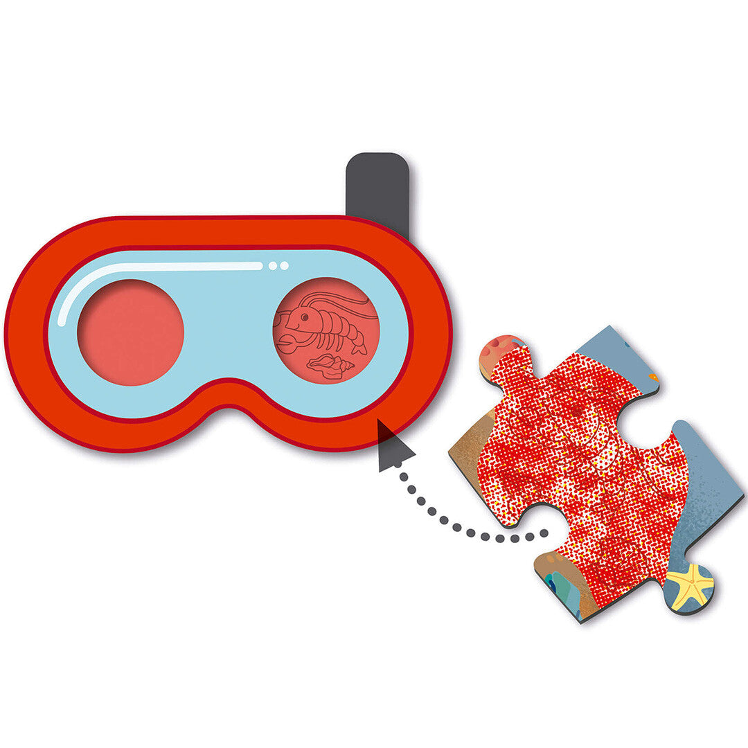 Detail van de Apli Kids kinderpuzzel met een rode duikbril die een verborgen kreeft onthult op een puzzelstukje.