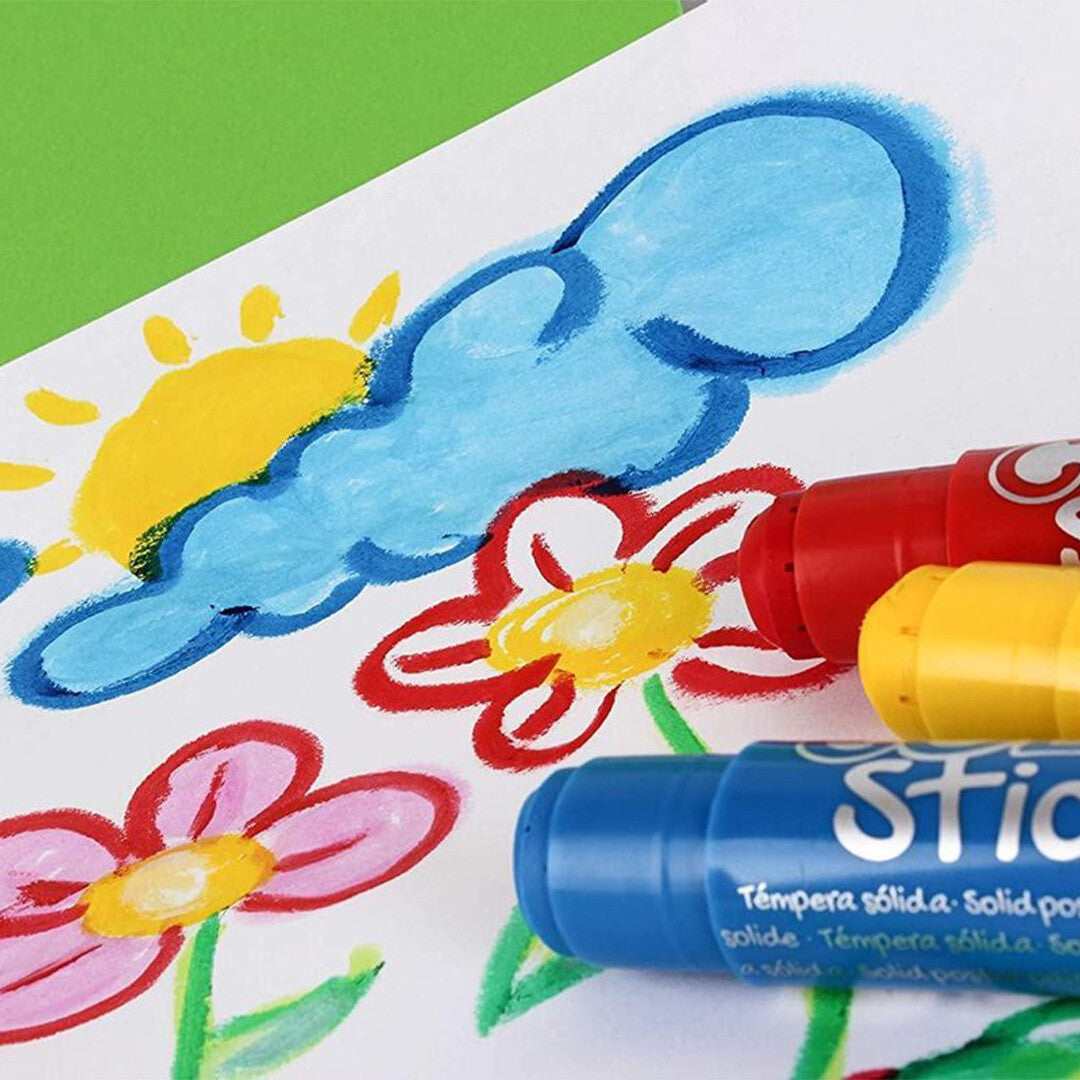Drie Apli Kids verfstiften liggen naast een kleurrijke tekening van bloemen, een zon en wolken.