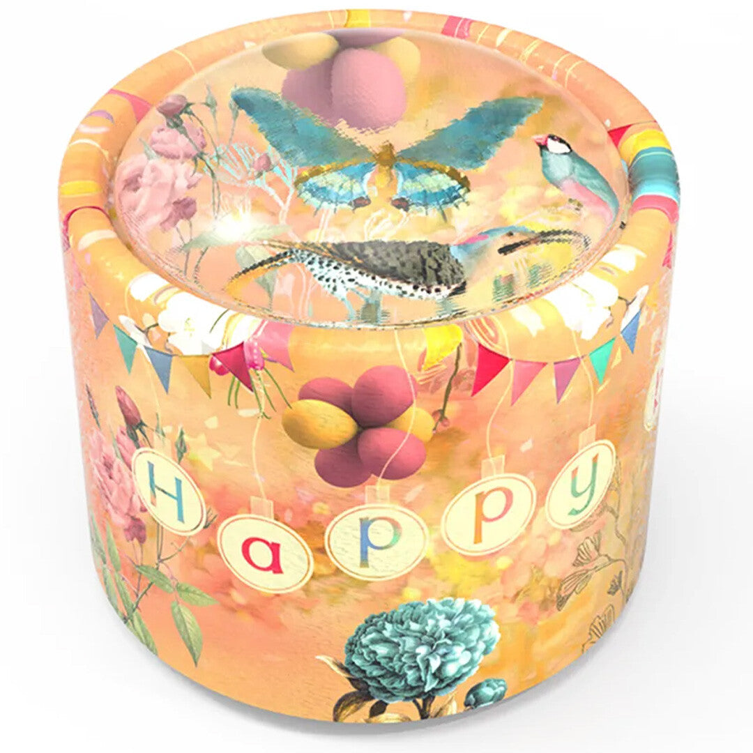 Belle Lurette muziekdoosje met 'Happy' tekst, vogels, vlinder, bloemen en ballonnen op een oranje achtergrond.
