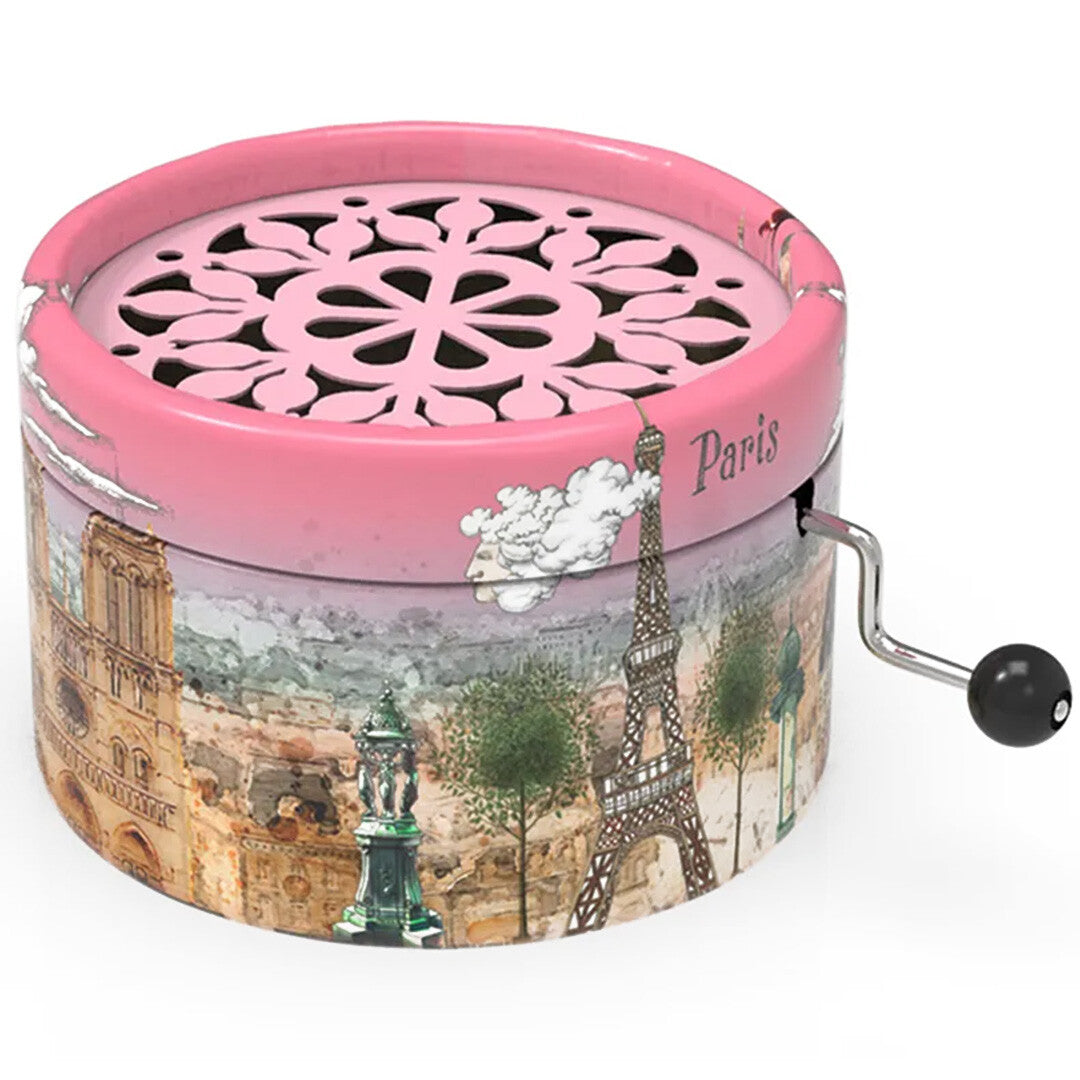 Belle Lurette roze muziekdoosje met Parijs-thema, inclusief de Eiffeltoren en Notre Dame, en een zwengel aan de zijkant.