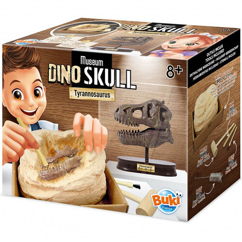 Verpakking van de Buki Dino Skull Tyrannosaurus opgraafkit voor educatief speelgoed, met afbeeldingen van een kind dat een schedel opgraaft en het eindresultaat.