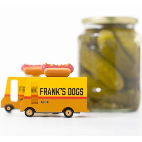 Twee candylab houten speelgoed hot dog vans met een pot augurken op de achtergrond.