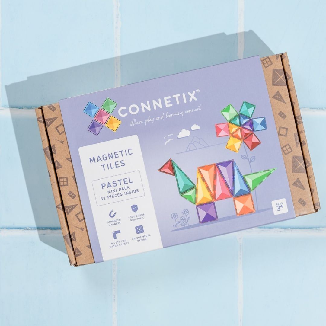 Verpakking van de Connetix magnetische tegels mini in pastelkleuren, liggend op een blauwe ondergrond.