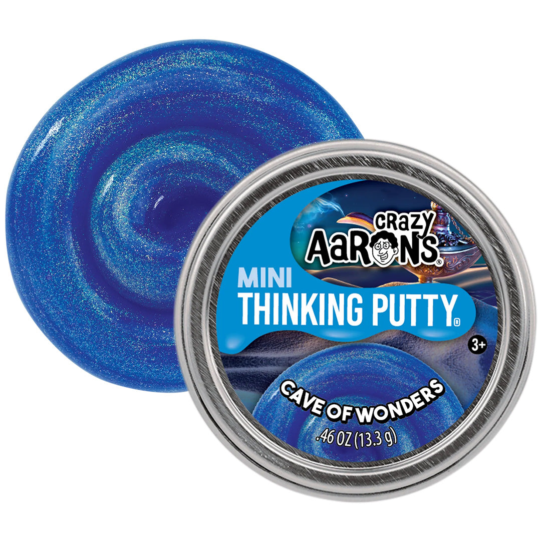 Crazy Aaron's Mini Thinking Putty 'Cave of Wonders' in blauw glitter naast de metalen verpakking.