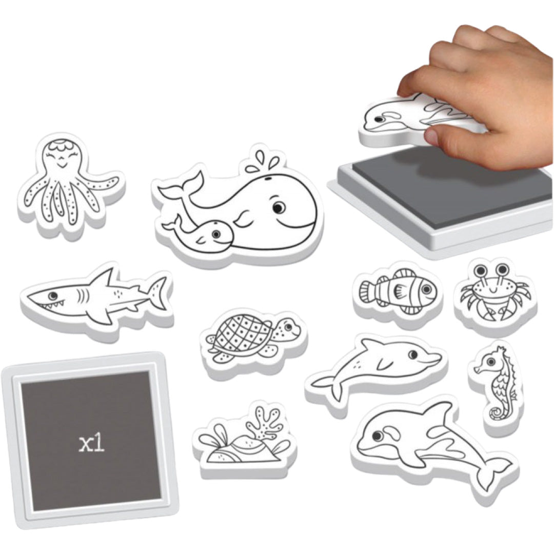 Crealign stempelset met witte rubberen zeedier stempels en een inktkussen, waarbij een hand een orka stempel indrukt.