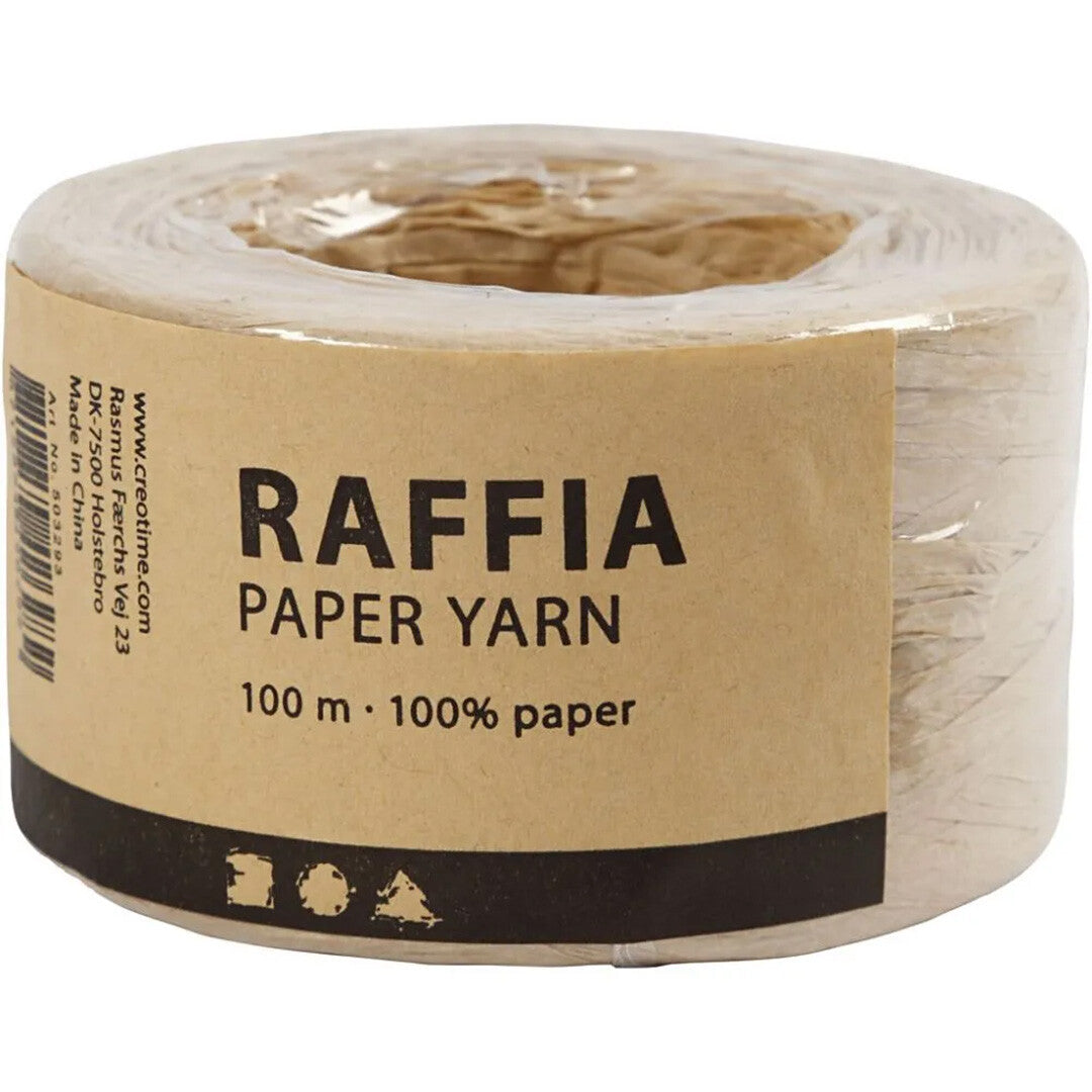 De verpakking van Creativ Company raffia papiergaren in zandkleur, met een label waarop 'RAFFIA PAPER YARN' staat.
