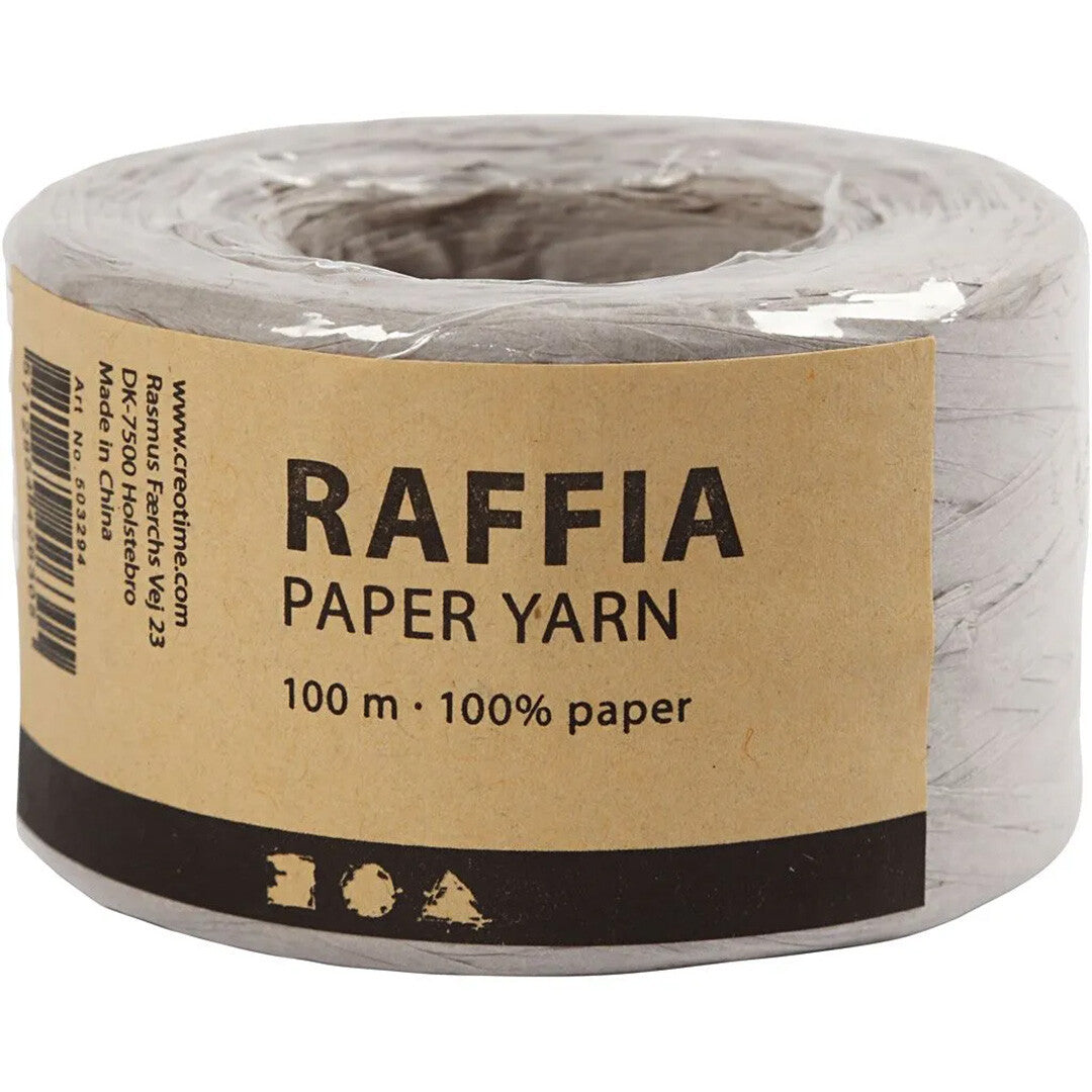 De verpakking van een rol lichtgrijs creativ company raffia papiergaren met productinformatie.