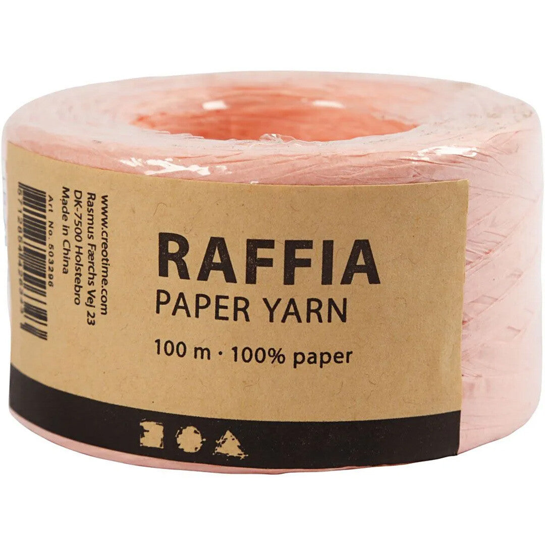 Verpakking van creativ company lichtroze raffia papiergaren met productinformatie op een bruin etiket.