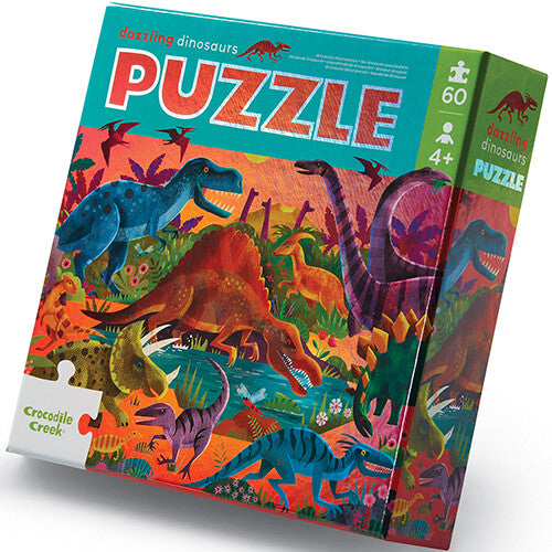 Crocodile Creek puzzelverpakking met een illustratie van diverse dinosaurussen.
