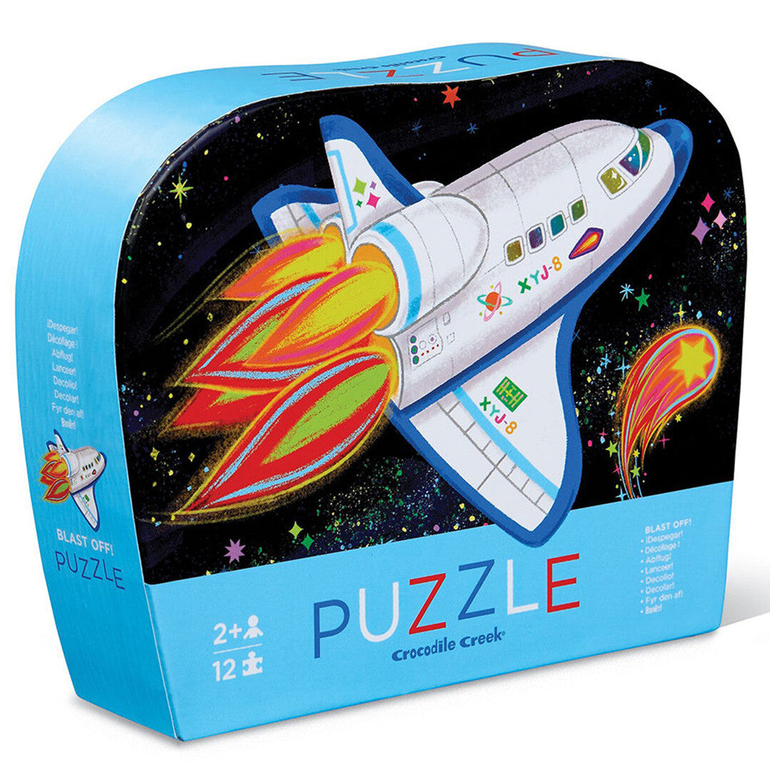 Verpakking van de Crocodile Creek kinderpuzzel met een ruimteschip in de ruimte.