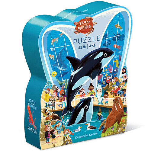 Crocodile Creek kinderpuzzel verpakking in de vorm van een aquarium met orka's en bezoekers.
