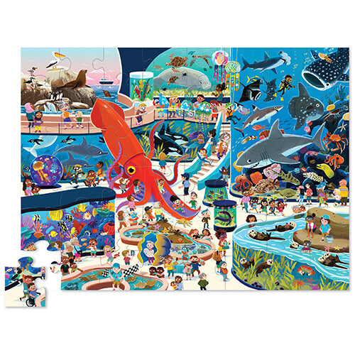 Voltooide kinderpuzzel van een drukbezocht aquarium met diverse zeedieren en mensen.