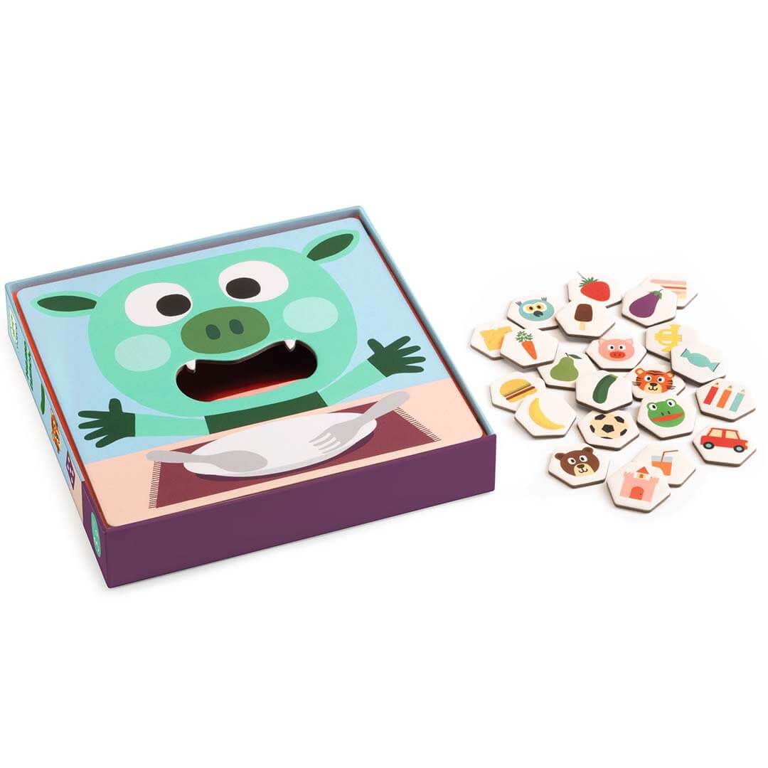 Open Djeco Memo Lunch geheugenspel doos met een groen monster en een stapel zeshoekige speeltegels.