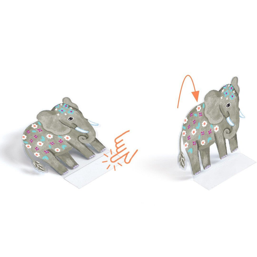 Detail van een grijze olifant sticker met bloemenpatroon die van plat naar 3D wordt gevouwen met een plakstrip.
