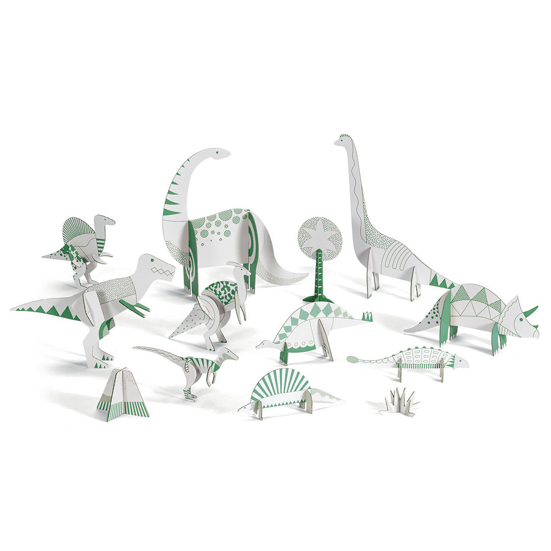Een collectie van ongekleurde 3D papieren dinosaurussen en planten van de Djeco knutselset.
