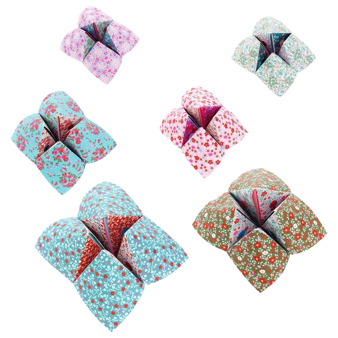 Vijf verschillende gevouwen origami vogelspellen met diverse bloemen- en geometrische patronen.