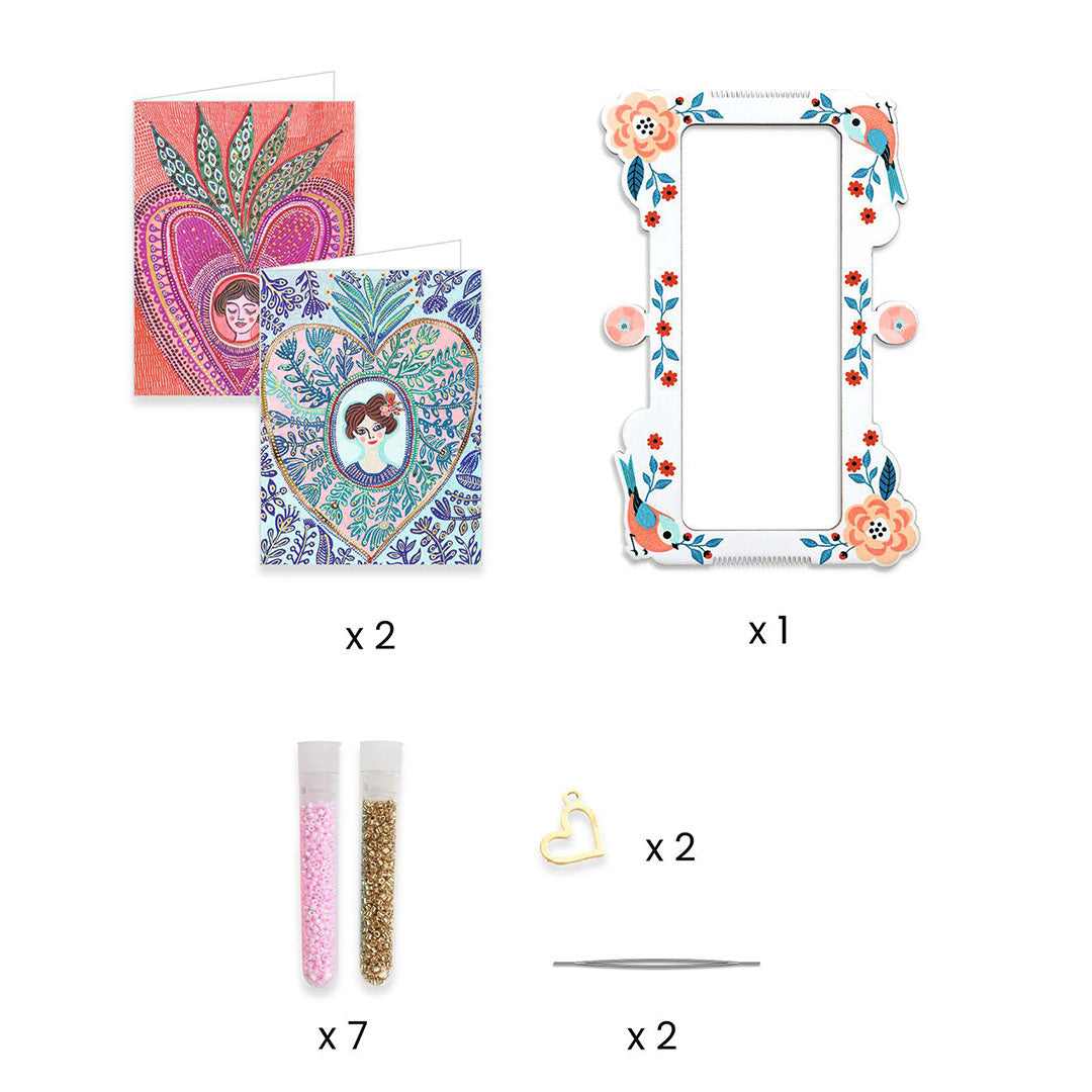 Overzicht van de onderdelen van de sieraden maken set, met kaarten, een lijst, kralen en hartvormige bedeltjes.