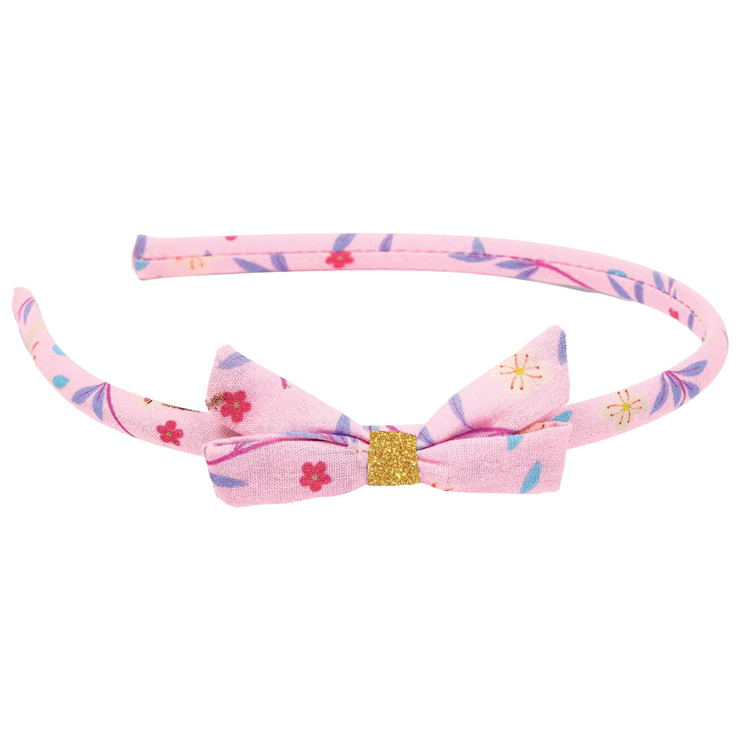 Djeco roze gebloemde haarband met strik en gouden glitter.