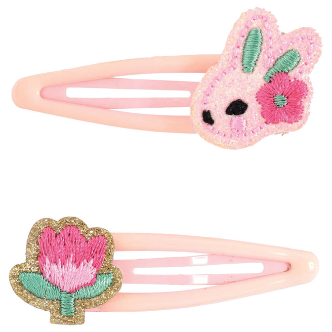 Djeco haarspeldjes met een roze konijn en een roze bloem.