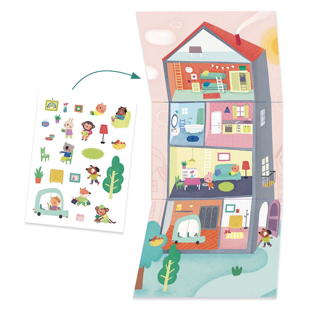 Materialen voor een Djeco knutselproject met een hoog huis en stickers van dieren en meubels om het te decoreren.