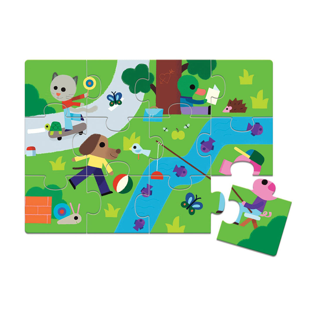 Djeco kinderpuzzel met een parktafereel van dieren en mensen, waarvan één stuk los ligt.